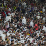 
              Spectators leave the stands before the end of the second half of the World Cup group E soccer match between Spain and Germany, at the Al Bayt Stadium in Al Khor , Qatar, Sunday, Nov. 27, 2022. (AP Photo/Luca Bruno)
            