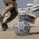 
              Afghan children play soccer on the outskirts of Kabul, Afghanistan, Friday, Nov. 11, 2022. (AP Photo/Ebrahim Noroozi)
            