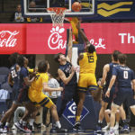 
              West Virginia forward Jimmy Bell Jr. (15) shoots while defended by Penn forward Nick Spinoso (13) during the first half of an NCAA college basketball game in Morgantown, W.Va., Friday, Nov. 18, 2022. (AP Photo/Kathleen Batten)
            