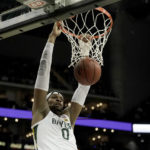 
              FILE - Baylor forward Flo Thamba dunks during the second half of the team's NCAA college basketball game against Oklahoma in the quarterfinals of the Big 12 tournament in Kansas City, Mo., March 10, 2022. While Baylor returnsonly two starters – guard Adam Flagler and big manThamba – the roster includes two guards coming back from injury, two Division I transfers and the league’s top incoming freshman. (AP Photo/Charlie Riedel, File)
            
