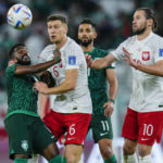 
              Saudi Arabia's Nawaf Al-Abed, left, and Poland's Krystian Bielik, center, fight for the ball during the World Cup group C soccer match between Poland and Saudi Arabia, at the Education City Stadium in Al Rayyan, Qatar, Saturday, Nov. 26, 2022. (AP Photo/Manu Fernandez)
            