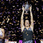 
              Caroline Garcia, right, of France, holds the trophy after defeating Aryna Sabalenka, left, of Belarus, in the singles final at the WTA Finals tennis tournament in Fort Worth, Texas, Monday, Nov. 7, 2022. (AP Photo/Ron Jenkins)
            