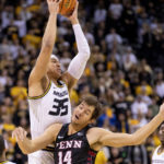 
              Missouri's Noah Carter, top, grabs a rebound over Penn's Max Martz, bottom, during the first half of an NCAA college basketball game Friday, Nov. 11, 2022, in Columbia, Mo. Missouri won 92-85. (AP Photo/L.G. Patterson)
            