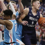 
              North Florida forward Carter Hendricksen, right, secures a rebound next to Gonzaga guard Malachi Smith, left, and Drew Timme during the first half of an NCAA college basketball game, Monday, Nov. 7, 2022, in Spokane, Wash. (AP Photo/Young Kwak)
            