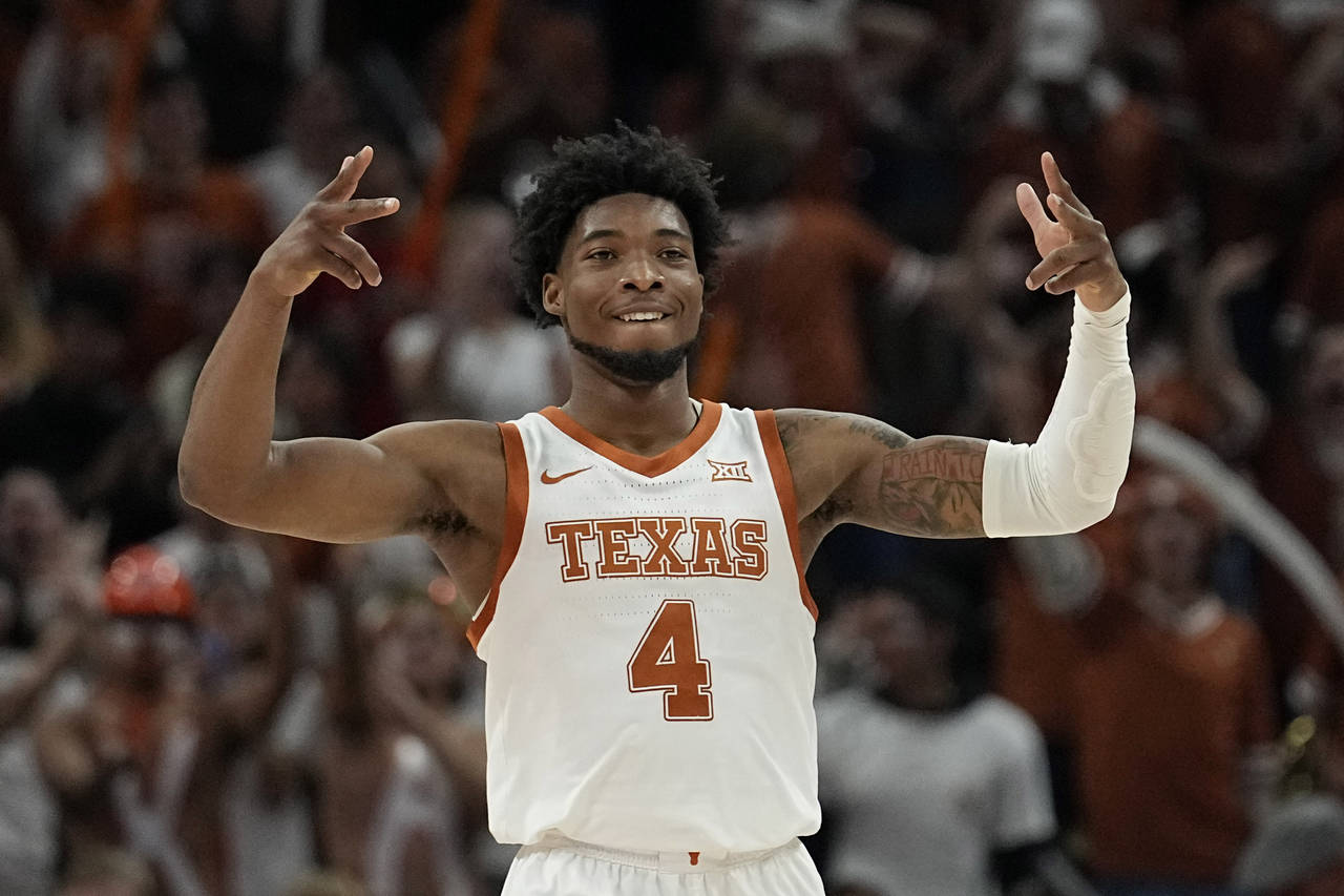Texas guard Tyrese Hunter (4) celebrate a score during the second half of an NCAA college basketbal...