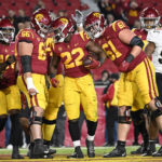 
              Southern California running back Darwin Barlow (22) is congratulated by offensive linemen Gino Quinones (66) and Joe Bryson (61) after scoring a touchdown in the fourth quarter of an NCAA college football game against Colorado, Friday, Nov. 11, 2022, in Los Angeles. (AP Photo/John McCoy)
            