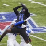 
              SMU wide receiver Rashee Rice (11) can't hold on to a pass as Memphis defensive back Quindell Johnson (15) and defensive back Sylvonta Oliver (11) defend during the first half of an NCAA college football game at Ford Stadium on Saturday, Nov. 26, 2022, in Dallas. (Smiley N. Pool/The Dallas Morning News via AP)
            