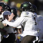 
              Oregon head coach Dan Lanning, left, congratulates Noah Sewell after he rushed for a 1-yard touchdown against Colorado in the first half of an NCAA college football game, Saturday, Nov. 5, 2022, in Boulder, Colo. (AP Photo/David Zalubowski)
            