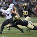 
              Northwestern running back Evan Hull (26) is tackled by Purdue defensive back Reese Taylor (1) during the first half of an NCAA college football game in West Lafayette, Ind., Saturday, Nov. 19, 2022. (AP Photo/Michael Conroy)
            
