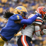 
              Pittsburgh defensive back Brandon Hill (9) tackles Syracuse running back Sean Tucker (34) during the first half of an NCAA college football game, Saturday, Nov. 5, 2022, in Pittsburgh. (AP Photo/Barry Reeger)
            