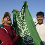
              Fans of Saudi Arabia celebrate their team 2-1 victory over Argentina in a World Cup group C soccer match, outside the Lusail Stadium in Lusail Qatar, Tuesday, Nov. 22, 2022. (AP Photo/Andre Penner)
            
