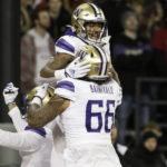 
              Washington wide receiver Ja'Lynn Polk, back, celebrates his touchdown with offensive lineman Henry Bainivalu during the first half of an NCAA college football game against Washington State, Saturday, Nov. 26, 2022, in Pullman, Wash. (AP Photo/Young Kwak)
            