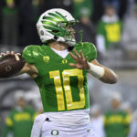 
              Oregon quarterback Bo Nix looks for a receiver during the first half of the team's NCAA college football game against Utah on Saturday, Nov. 19, 2022, in Eugene, Ore. (AP Photo/Andy Nelson)
            