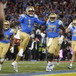 
              UCLA quarterback Dorian Thompson-Robinson (1) celebrates as he scores a touchdown during the first half of an NCAA college football game against Southern California Saturday, Nov. 19, 2022, in Pasadena, Calif. (AP Photo/Mark J. Terrill)
            