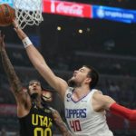
              Utah Jazz guard Jordan Clarkson, left, shoots as Los Angeles Clippers center Ivica Zubac defends during the first half of an NBA basketball play-in tournament game Sunday, Nov. 6, 2022, in Los Angeles. (AP Photo/Mark J. Terrill)
            