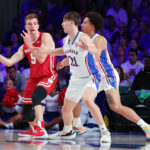 
              In a photo provided by Bahamas Visual Services, Wisconsin's Tyler Wahl (5) passes the ball during an NCAA college basketball game against Kansas in the Battle 4 Atlantis at Paradise Island, Bahamas, Thursday, Nov. 24, 2022. (Tim Aylen/Bahamas Visual Services via AP)
            