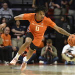 
              Illinois' Terrence Shannon Jr. reaches for the ball during the first half of an NCAA college basketball game against Monmouth, Monday, Nov. 14, 2022, in Champaign, Ill. (AP Photo/Michael Allio)
            