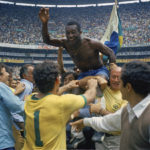 
              FILE - Brazil's Pele, center, is hoisted on the shoulders of his teammates after Brazil won the World Cup soccer final against Italy, 4-1, in Mexico City's Estadio Azteca, Mexico. Brazil's third World Cup triumph meant it kept the Jules Rimet trophy for good. The Hand of God. Zidane's headbutt. Gazza's tears. Many of soccer's most iconic moments have taken place at the World Cup, the latest edition of which starts in Qatar on Sunday. The Associated Press has covered the tournament through the years and followed the world's greatest players, none more so than Diego Maradona and Pelé.(AP Photo, file)
            