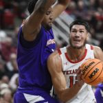 
              Texas Tech forward Daniel Batcho (12) drives to the basket against Northwestern State center Jordan Wilmore during the first half of an NCAA college basketball game Monday, Nov. 7, 2022, in Lubbock, Texas. (AP Photo/Justin Rex)
            