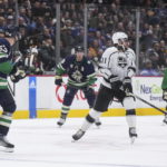 
              Los Angeles Kings' Anze Kopitar (11) is struck by the puck off the stick of Vancouver Canucks' Bo Horvat (53) during the second period of an NHL hockey game Friday, Nov. 18, 2022, in Vancouver, British Columbia. (Darryl Dyck/The Canadian Press via AP)
            
