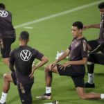 
              Germany's Jamal Musiala stretches besides team mates during a training session at the Al-Shamal stadium on the eve of the group E World Cup soccer match between Germany and Spain, in Al-Ruwais, Qatar, Friday, Nov. 25, 2022. Germany will play the second match against Spain on Sunday, Nov. 27. (AP Photo/Matthias Schrader)
            