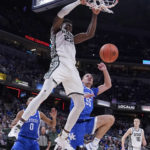 
              Michigan State center Mady Sissoko (22) scores over Kentucky forward Lance Ware (55) during overtime of an NCAA college basketball game, Tuesday, Nov. 15, 2022, in Indianapolis. (AP Photo/Darron Cummings)
            