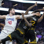 
              Los Angeles Clippers center Ivica Zubac (40) reaches for the ball next to Golden State Warriors forward Draymond Green (23) and forward Andrew Wiggins during the first half of an NBA basketball game in San Francisco, Wednesday, Nov. 23, 2022. (AP Photo/Jeff Chiu)
            
