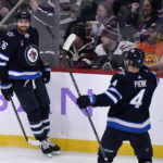 
              Winnipeg Jets' Blake Wheeler (26) celebrates his hat-trick goal against the Colorado Avalanche with Neal Poink (4) during the third period of an NHL hockey game Tuesday, Nov. 29, 2022, in Winnipeg, Manitoba. (Fred Greenslade/The Canadian Press via AP)
            