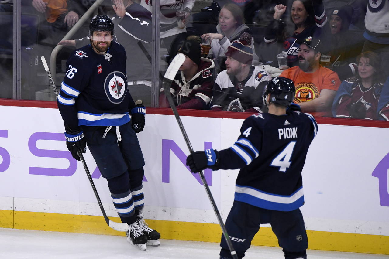 Winnipeg Jets' Blake Wheeler (26) celebrates his hat-trick goal against the Colorado Avalanche with...