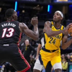 
              Indiana Pacers guard Buddy Hield (24) looks to pass over Miami Heat center Bam Adebayo (13) during the second half of an NBA basketball game in Indianapolis, Friday, Nov. 4, 2022. The Pacers defeated the Heat 101-99. (AP Photo/Michael Conroy)
            