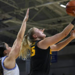 
              Iowa forward Monika Czinano, right, drives to the basket ahead of Drake forward Grace Berg during the first half of an NCAA college basketball game, Sunday, Nov. 13, 2022, in Des Moines, Iowa. (AP Photo/Charlie Neibergall)
            