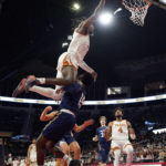 
              Texas guard Marcus Carr (5) is fouled by Northern Arizona guard Jalen Cone (15) as he drives to the basket during the first half of an NCAA college basketball game, Monday, Nov. 21, 2022, in Edinburg, Texas. (AP Photo/Eric Gay)
            