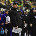 
              Washington head coach Kalen DeBoer, center, watches a replay during the first half of an NCAA college football game against Oregon, Saturday, Nov. 12, 2022, in Eugene, Ore. (AP Photo/Andy Nelson)
            