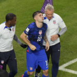
              Christian Pulisic of the United States is helped by team doctors after he scoring his side's opening goal during the World Cup group B soccer match between Iran and the United States at the Al Thumama Stadium in Doha, Qatar, Tuesday, Nov. 29, 2022. (AP Photo/Luca Bruno)
            
