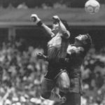 
              FILE - Argentina's Diego Maradona, left, beats England goalkeeper Peter Shilton to a high ball and scores his first of two goals in a World Cup quarterfinal soccer match, in Mexico City on June 22, 1986. This goal has gone down as the "Hand of God" as Maradona used his left fist to knock a ball past England's Shilton. (El Grafico, Buenos Aires via AP/File)
            