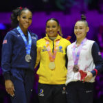 
              Gold medalist Rebeca Andrade of Brazil, centre, Silver medalist Shilese Jones of the U.S., left, and Bronze medalist Great Britain's Jessica Gadirova celebrate during a medal ceremony for the Women's All-Around Final during the Artistic Gymnastics World Championships at M&S Bank Arena in Liverpool, England, Thursday, Nov. 3, 2022. (AP Photo/Jon Super)
            