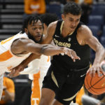
              Tennessee guard Josiah-Jordan James vies for the ball with Colorado forward Greg Gerhardt, right, during the first half of an NCAA college basketball game Sunday, Nov. 13, 2022, in Nashville, Tenn. (AP Photo/John Amis)
            