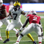 
              Michigan running back Donovan Edwards (7) rushes against Rutgers defensive back Avery Young (2) during the first half of an NCAA football game, Saturday, Nov. 5, 2022 in Piscataway, N.J. (AP Photo/Noah K. Murray)
            