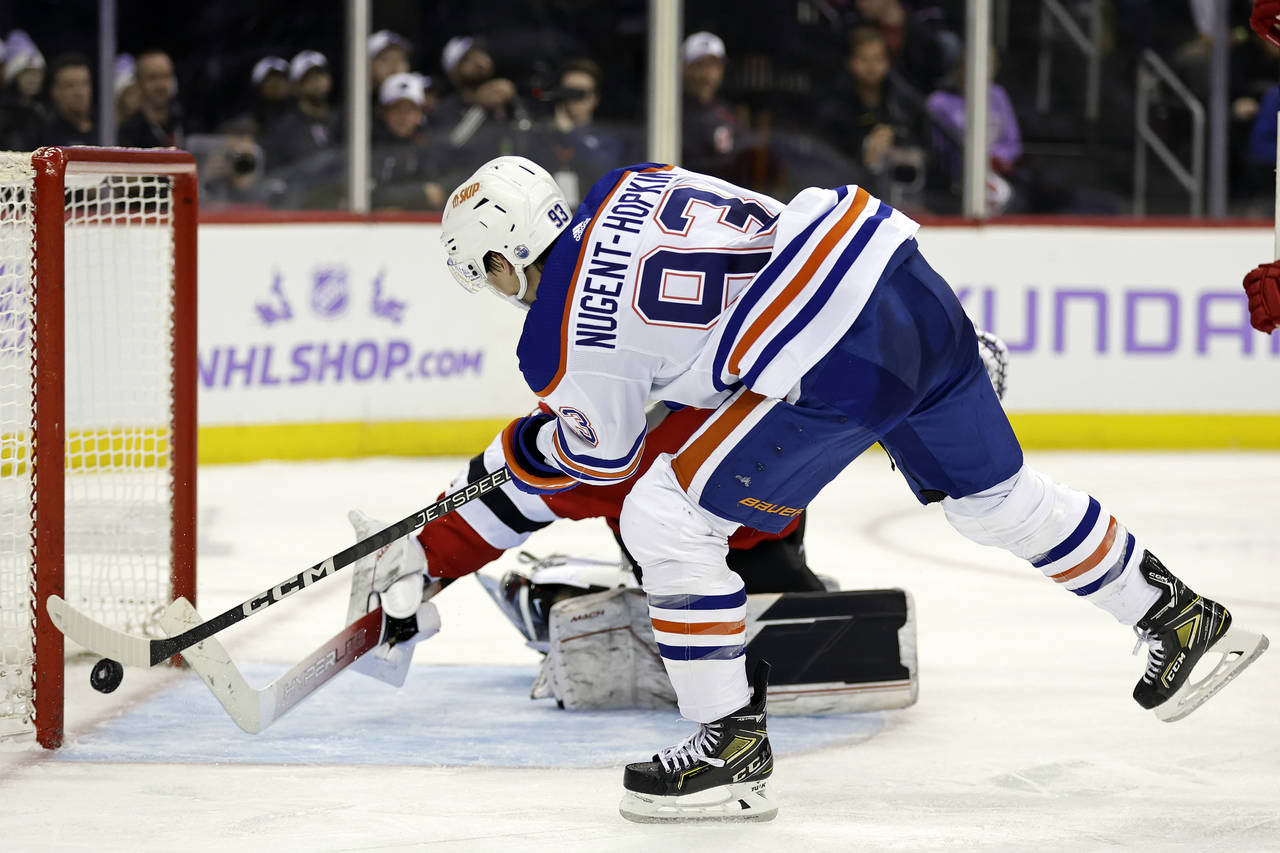 Edmonton Oilers center Ryan Nugent-Hopkins (93) scores a goal past New Jersey Devils goaltender Vit...