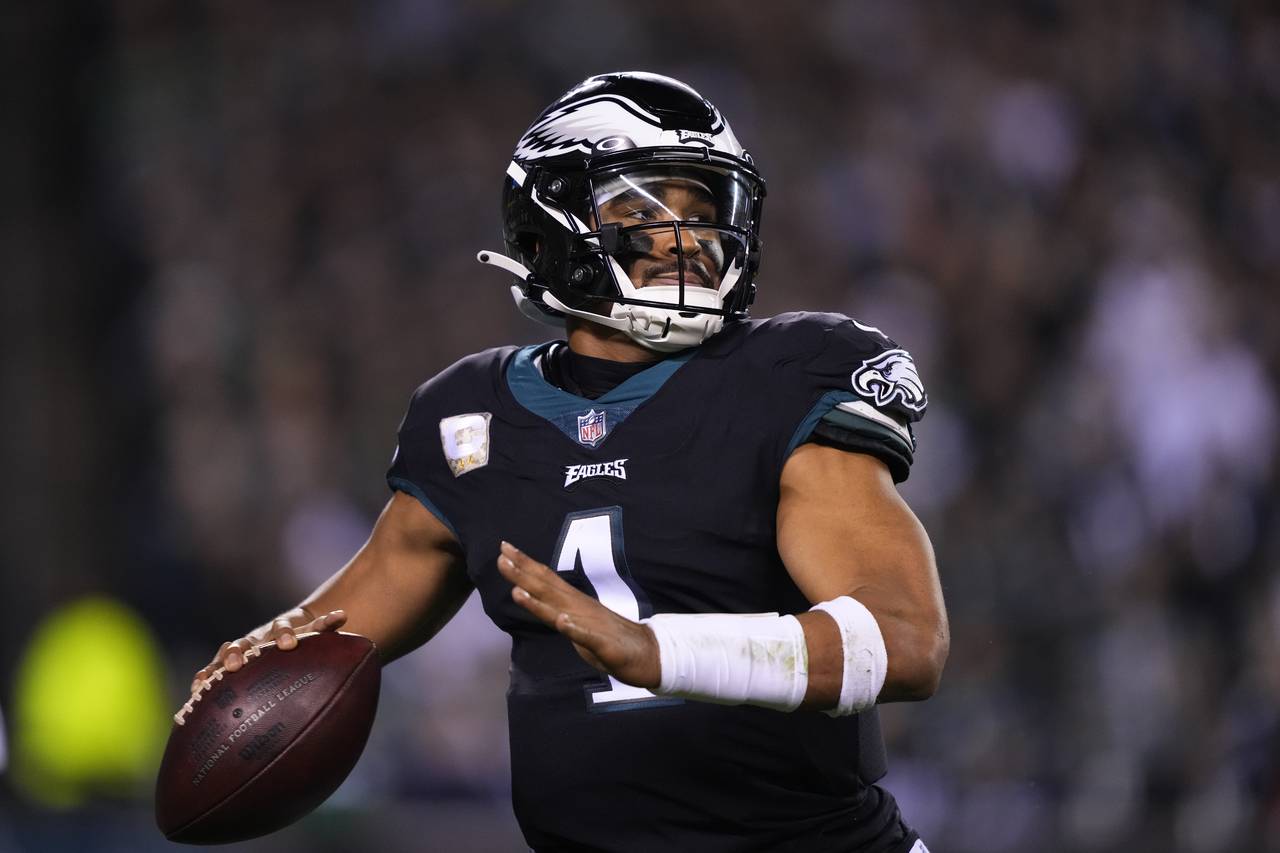 Philadelphia Eagles quarterback Jalen Hurts throws during the first half of an NFL football game ag...