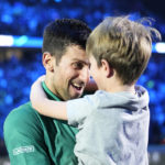 
              Serbia's Novak Djokovic celebrates with his son after defeating Norway's Casper Ruud 7-5, 6-3, in their singles final tennis match of the ATP World Tour Finals at the Pala Alpitour, in Turin, Italy, Sunday, Nov. 20, 2022. (AP Photo/Antonio Calanni)
            
