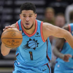 
              Phoenix Suns guard Devin Booker (1) brings the ball up during the second half of the team's NBA basketball game against the Utah Jazz on Friday, Nov. 18, 2022, in Salt Lake City. (AP Photo/Rick Bowmer)
            