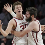 
              Oklahoma forward Jacob Groves (34) and forward Tanner Groves (35) celebrate in the finals second of the team's win over South Alabama in an NCAA college basketball game Friday, Nov. 18, 2022, in Norman, Okla. (AP Photo/Sue Ogrocki)
            
