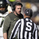 
              Oregon head coach Dan Lanning confers with side judge Dion Spenard in the first half of an NCAA college football game against Colorado, Saturday, Nov. 5, 2022, in Boulder, Colo. (AP Photo/David Zalubowski)
            