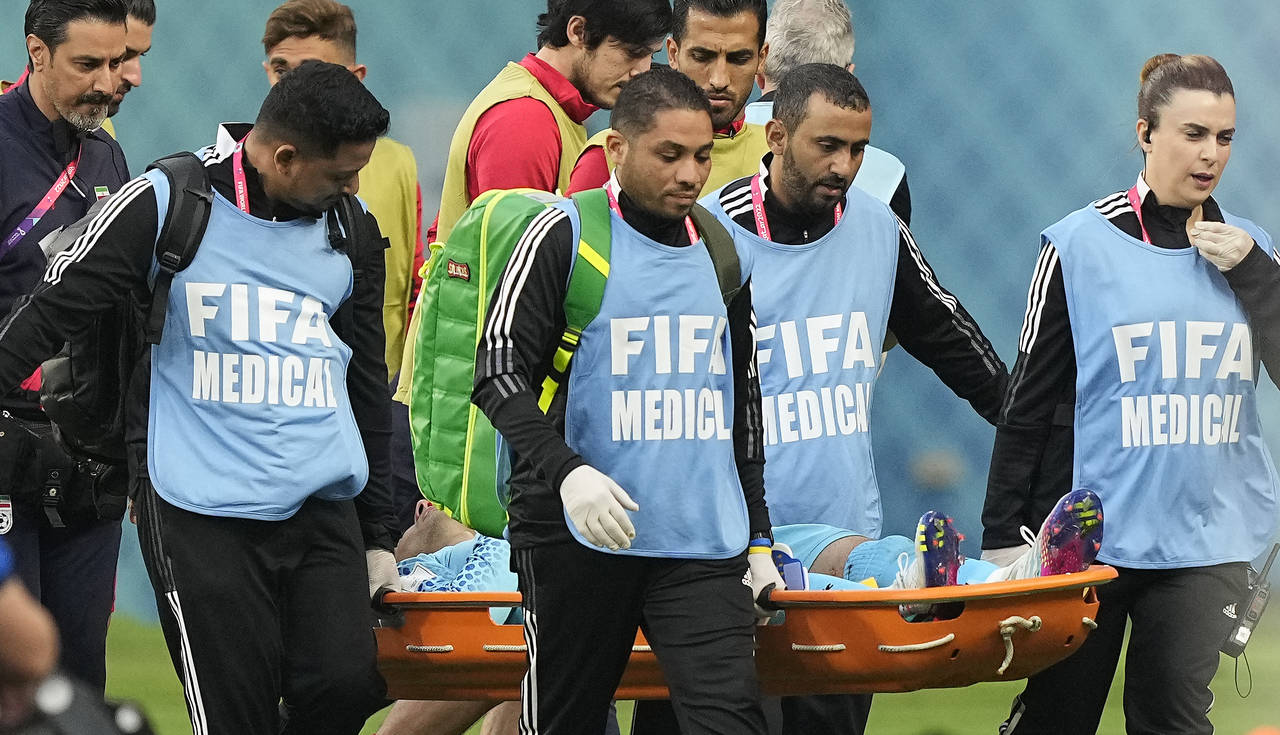 Iran's goalkeeper Alireza Beiranvand is carried out of the stadium injured during the World Cup gro...