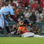 
              Philadelphia Phillies first baseman Rhys Hoskins tags Houston Astros' Yuli Gurriel in a run down during the seventh inning in Game 5 of baseball's World Series between the Houston Astros and the Philadelphia Phillies on Thursday, Nov. 3, 2022, in Philadelphia. (AP Photo/David J. Phillip)
            