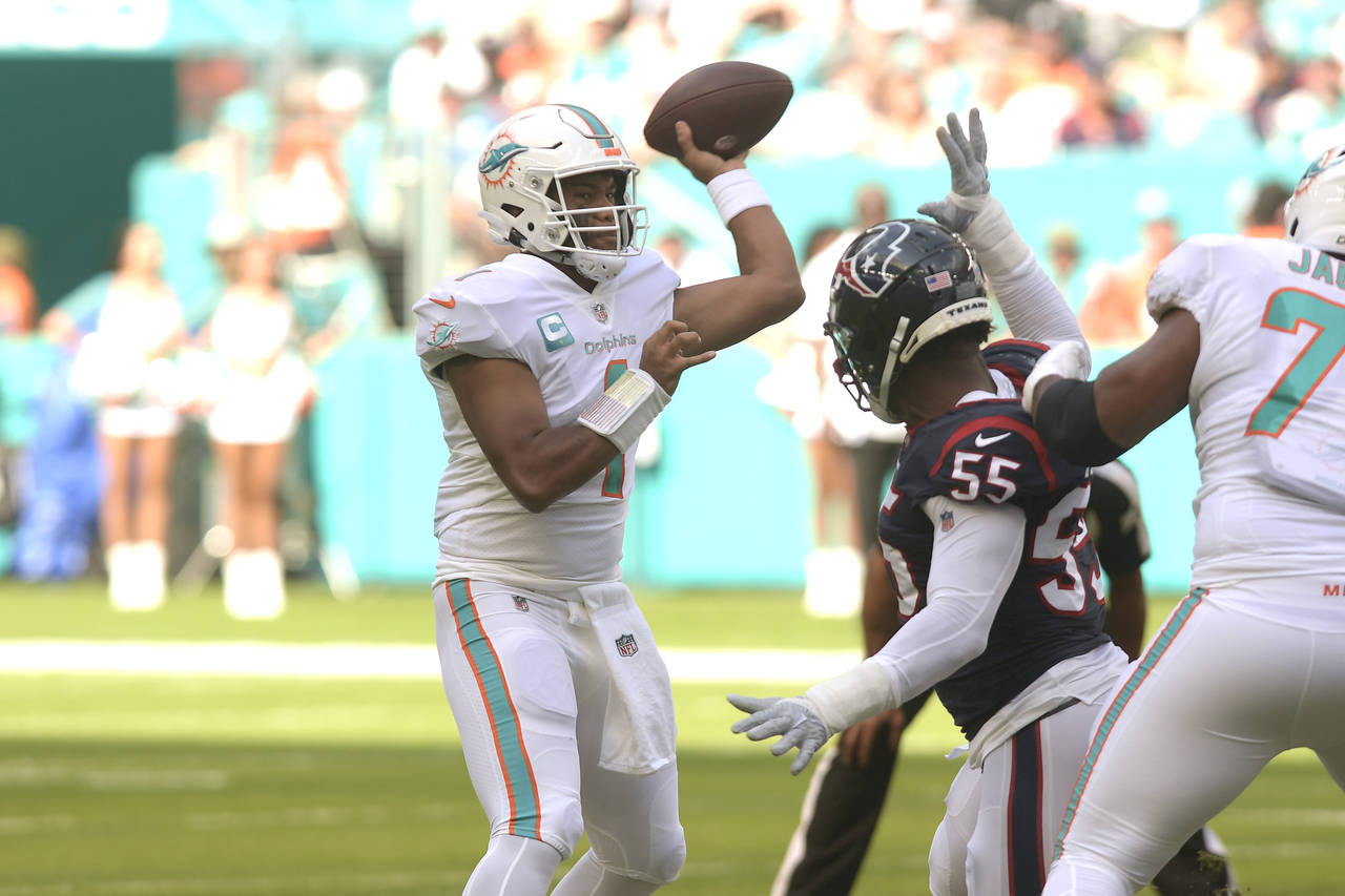 Miami Dolphins quarterback Tua Tagovailoa (1) aims a pass during the first half of an NFL football ...