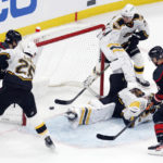 
              Carolina Hurricanes' Jesperi Kotkaniemi (82) scores on Boston Bruins' Linus Ullmark (35) during the first period of an NHL hockey game, Friday, Nov. 25, 2022, in Boston. (AP Photo/Michael Dwyer)
            