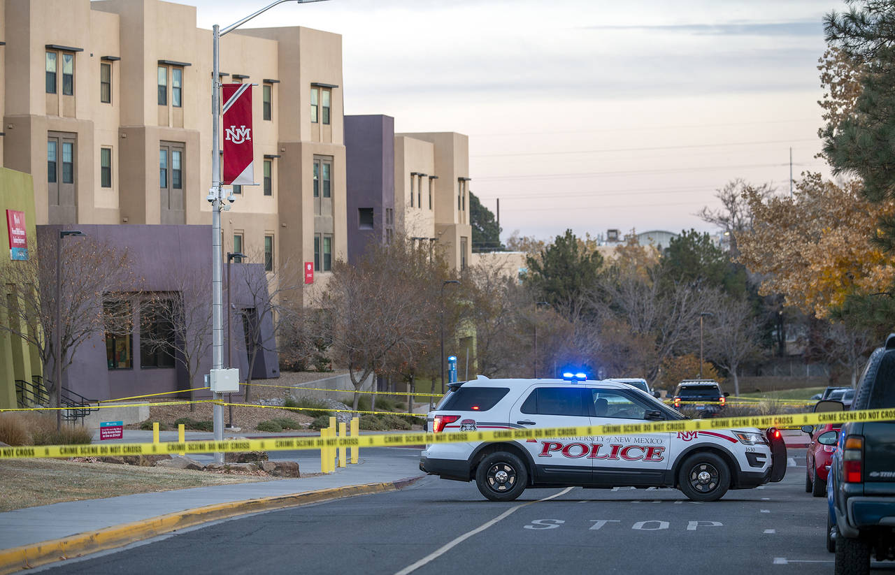 New Mexico State Police assists APD officers in investigating a deadly overnight shooting at Corona...