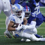 
              Detroit Lions wide receiver Amon-Ra St. Brown (14) runs the ball against New York Giants linebacker Jaylon Smith (54) during the second half of an NFL football game, Sunday, Nov. 20, 2022, in East Rutherford, N.J. (AP Photo/Seth Wenig)
            